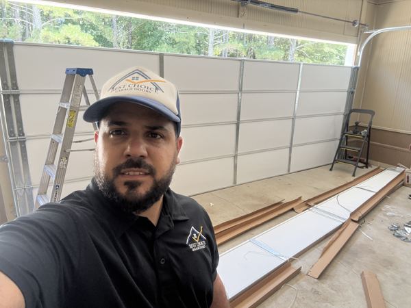 Garage door repair technician fixing a residential door in Atlanta