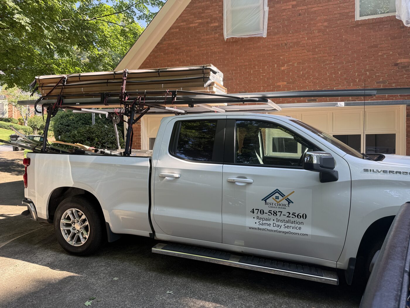 Best Choice Garage Doors truck loaded with new garage door sections on site, Roswell GA