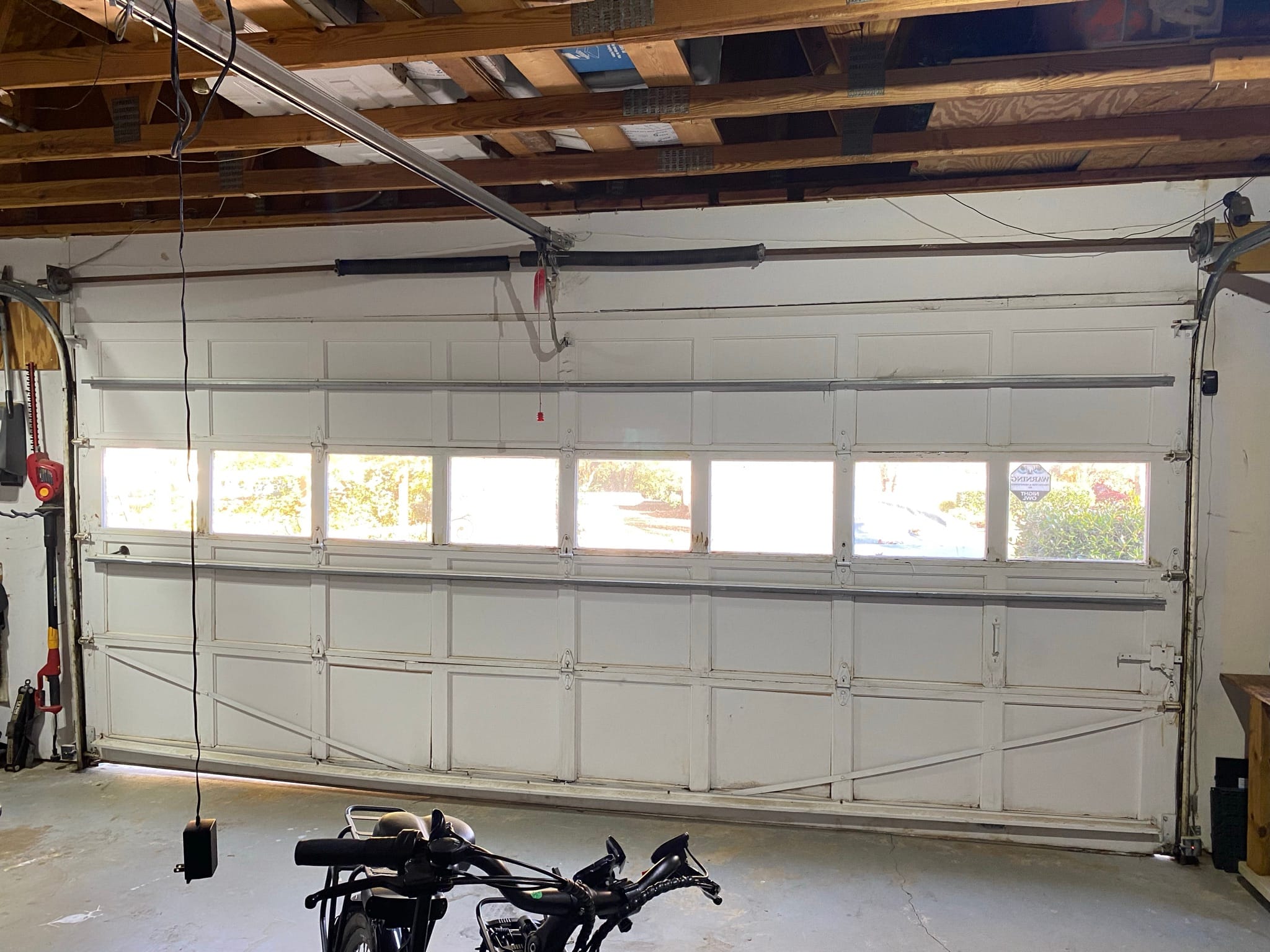 Old wooden garage door before replacement at a home in Avalon, Alpharetta GA