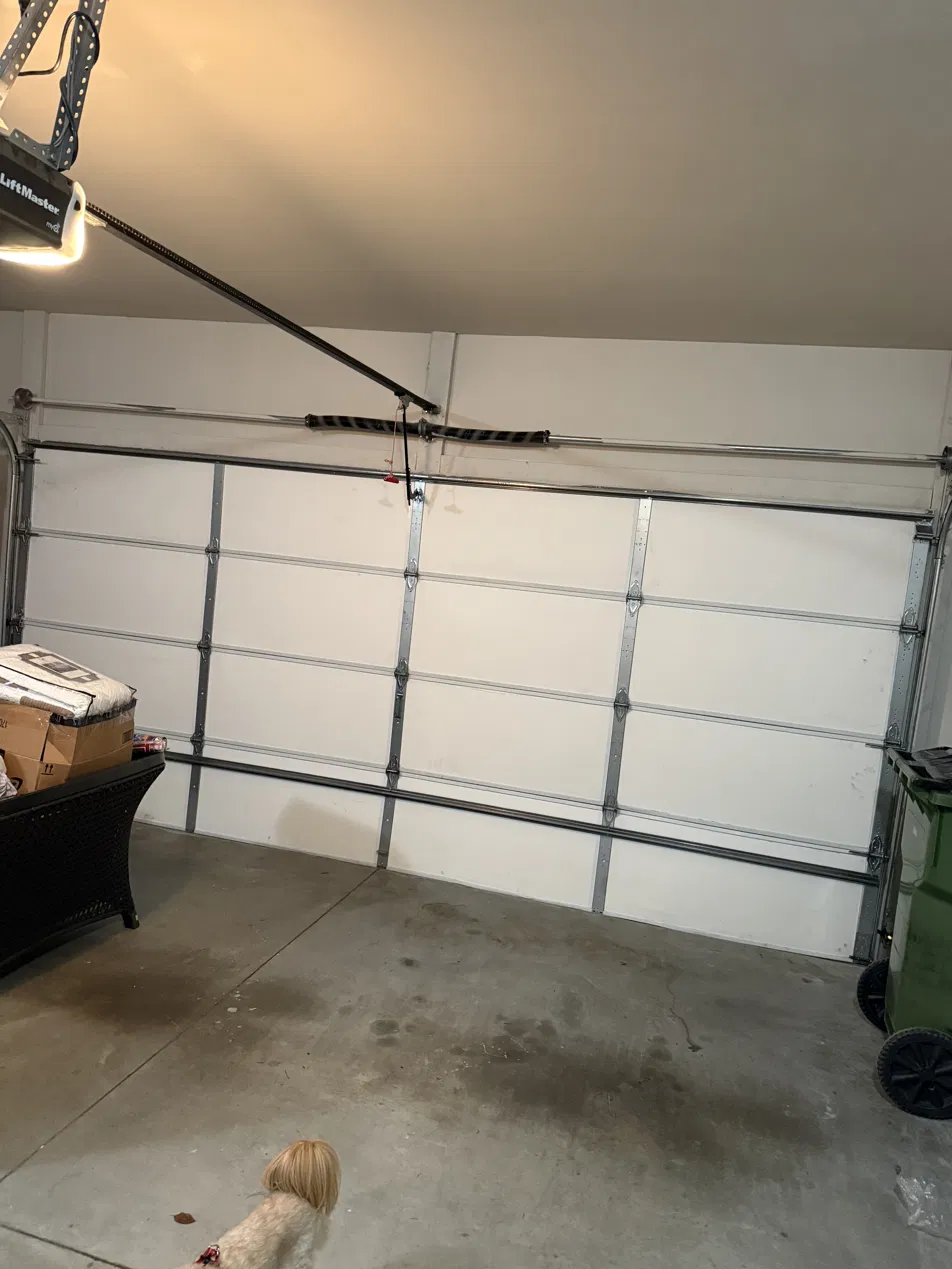 Repaired garage door seated back in its tracks and closed in Buckhead Atlanta