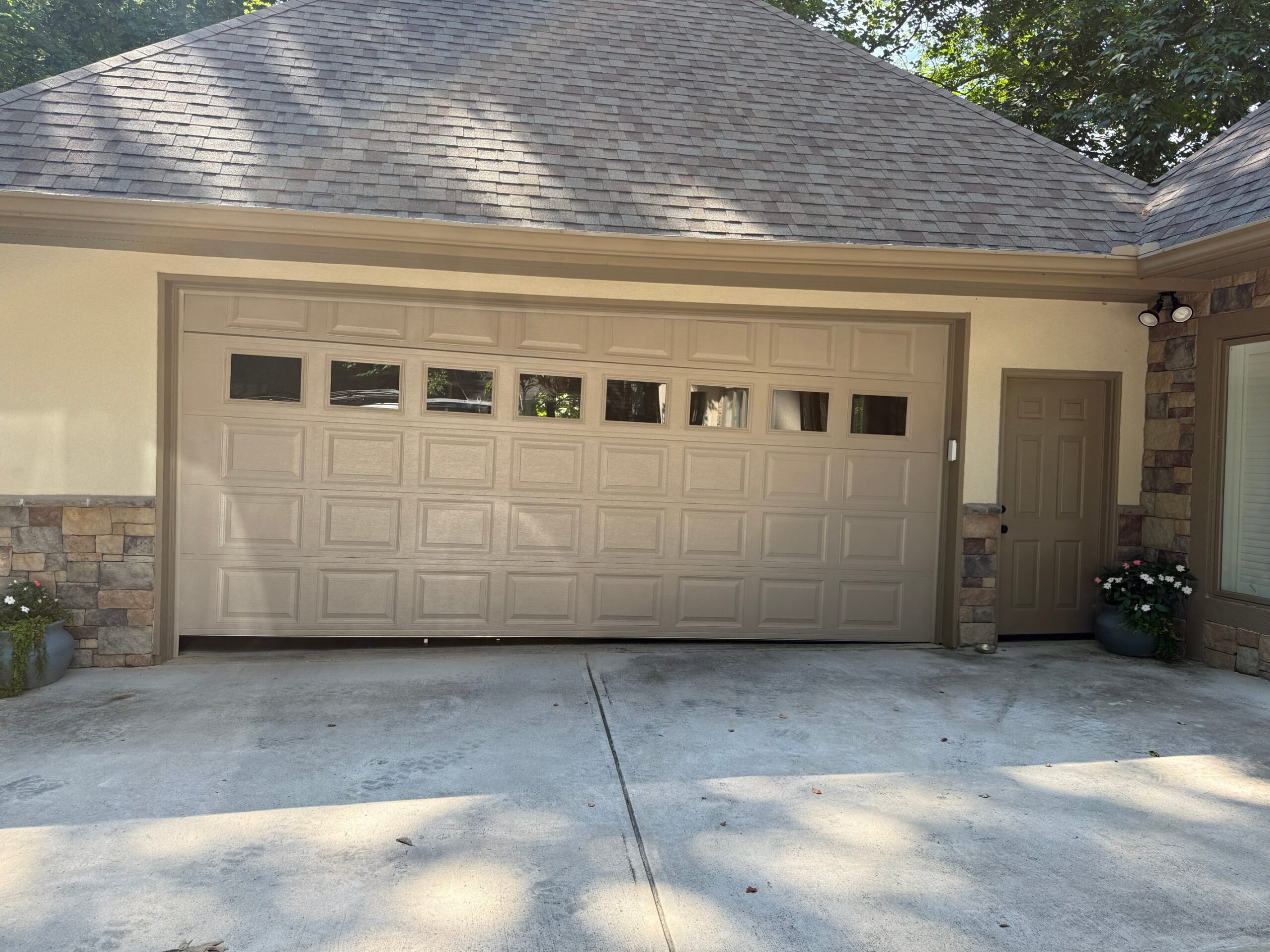 Double garage door hanging crooked and off its track in Chamblee, GA, before repair by Best Choice Garage Doors