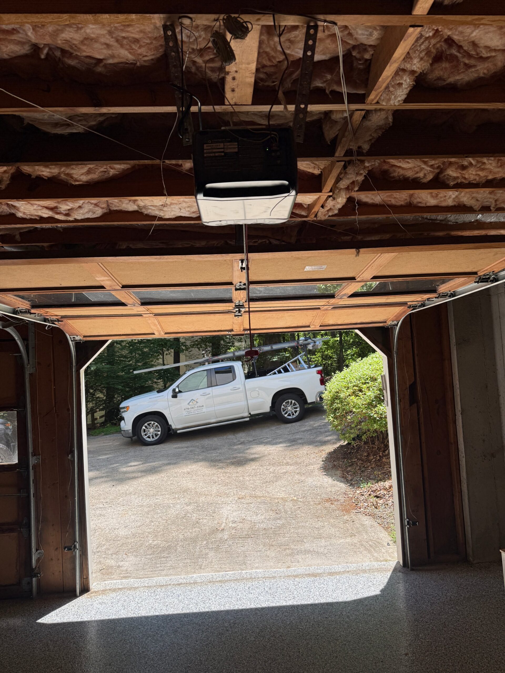 Best Choice Garage Doors service truck parked outside an open garage after a new opener installation in Buford, GA