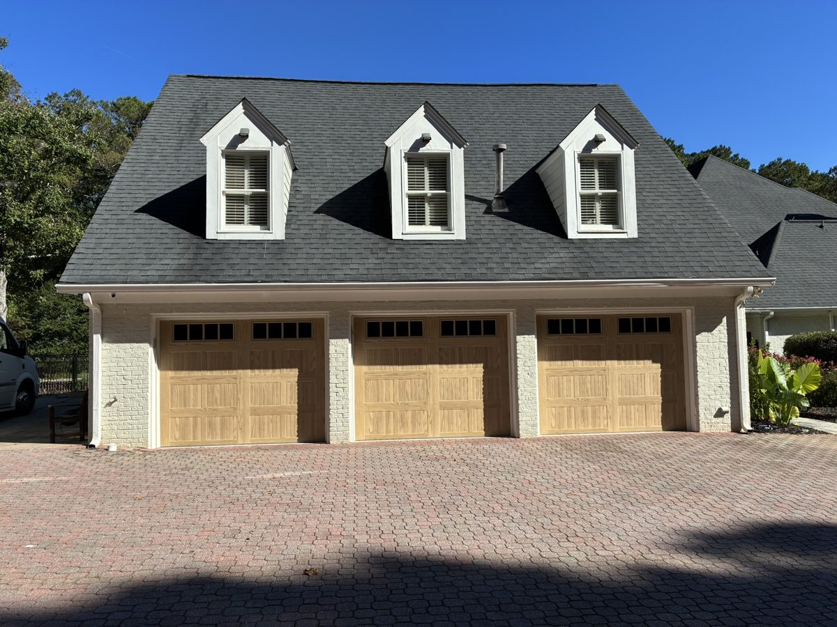 Three CHI 5283 carriage-house garage doors in Natural Oak installed by Best Choice Garage Doors