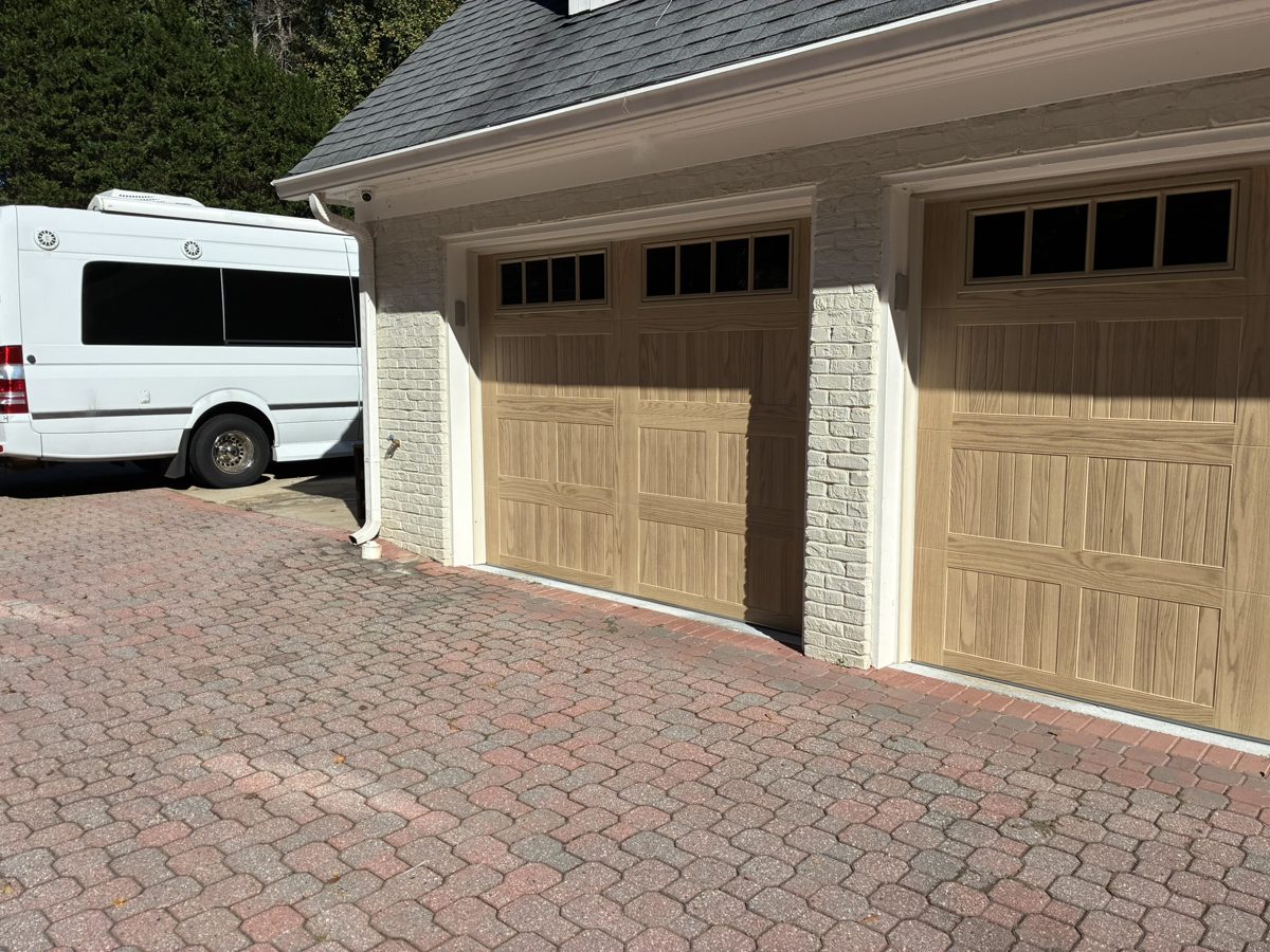 Close-up of new CHI 5283 Natural Oak carriage-style garage doors installed in Alpharetta, GA