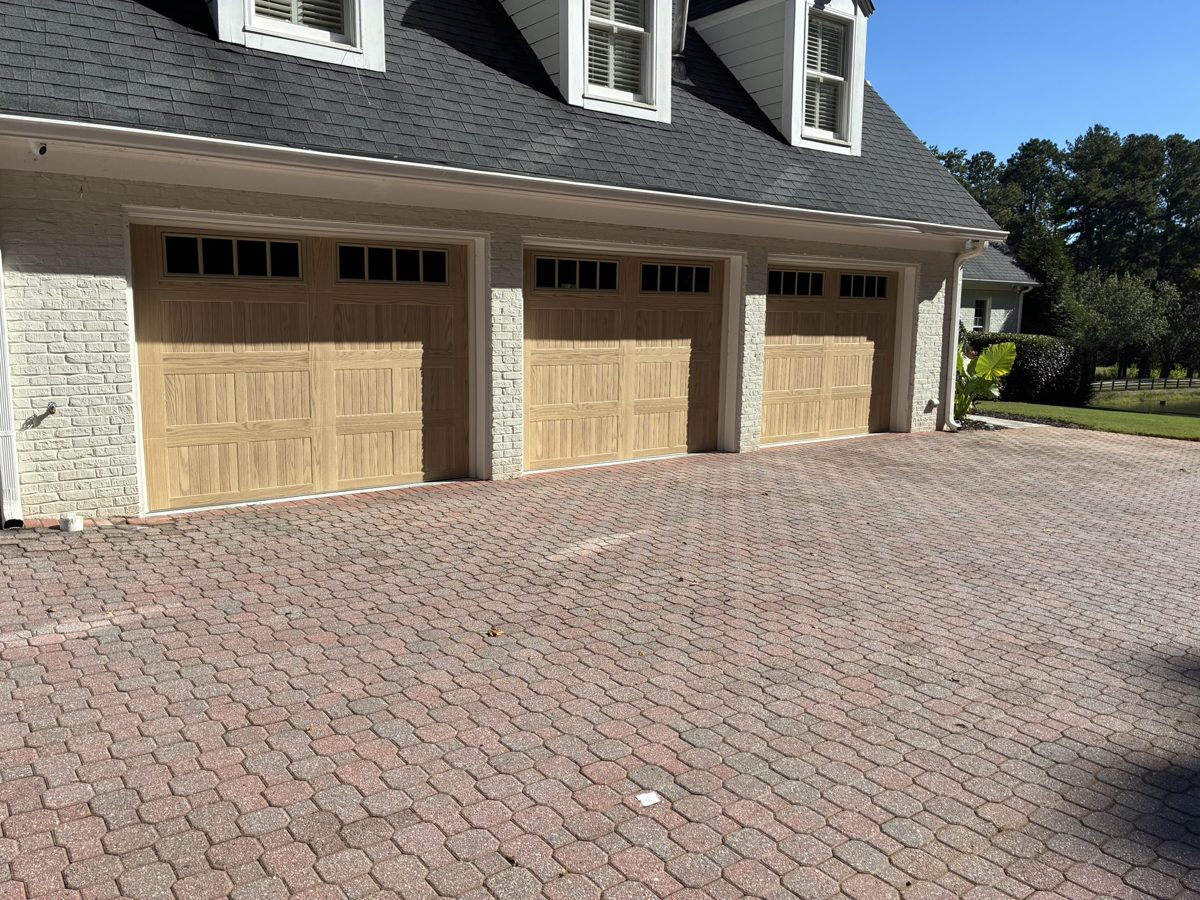 CHI 5283 Natural Oak carriage garage doors with window inserts on a three-car garage in Alpharetta, GA